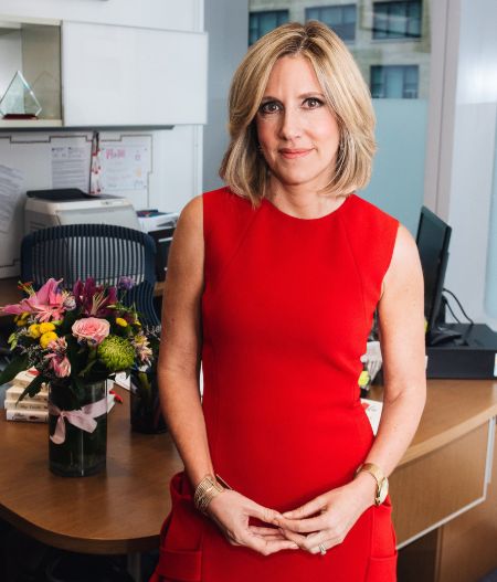 Alisyn Camerota poses for a picture in a red dress.